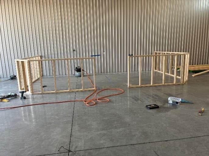 Stud walls framed out on the retail floor for the new sales counter