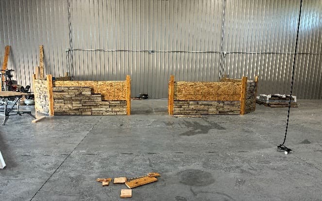 Both sales counter stations with stone veneer and timber posts nearly complete