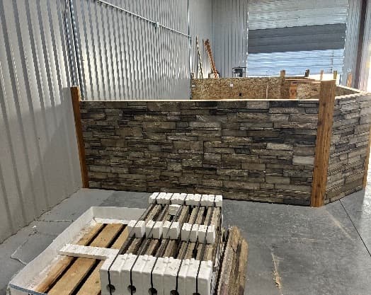 Stone veneer and timber trim going up on the front of the new sales counter