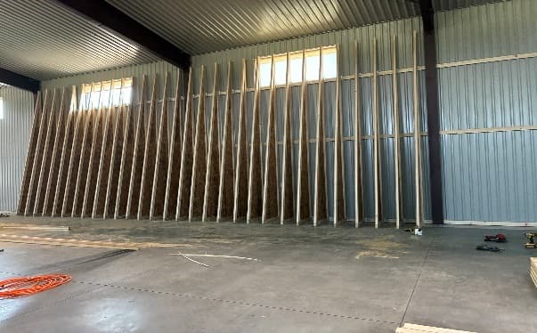 Wall studs staged along the interior of the lumber warehouse